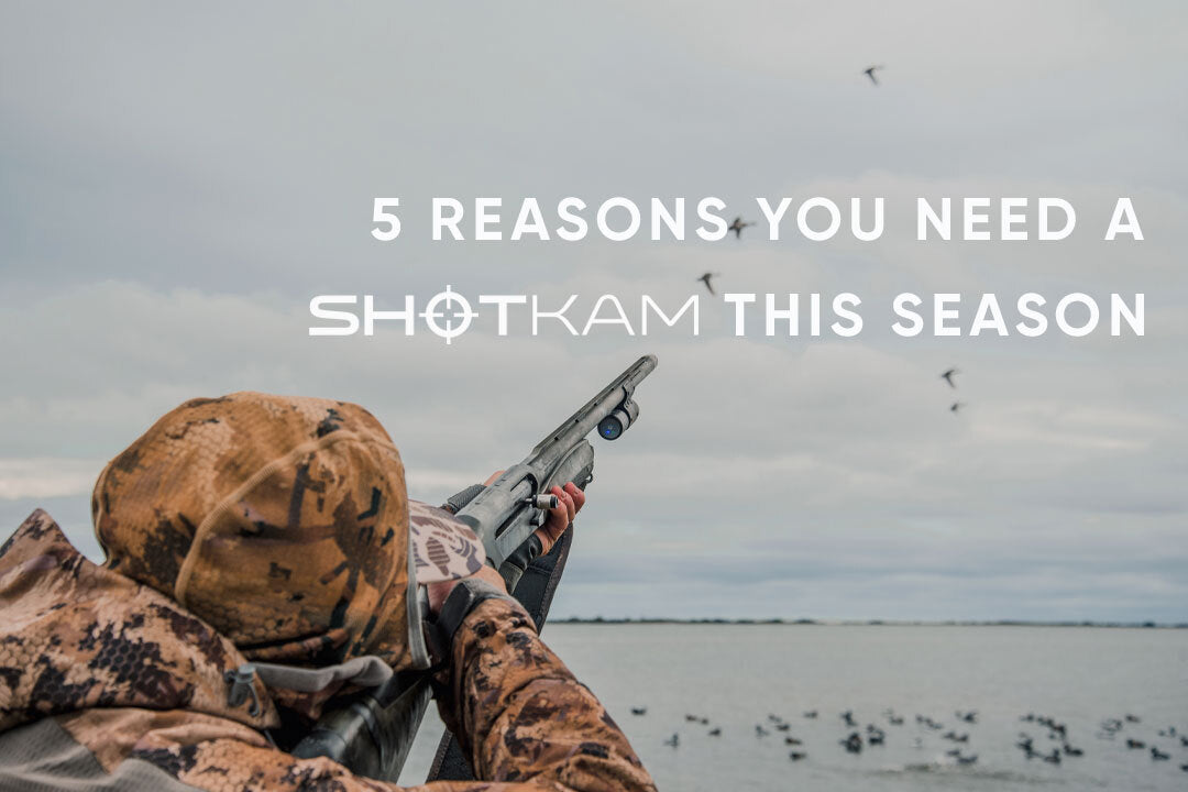 Outdoor hunting scene with man in camouflage aiming shotgun fitted with ShotKam camera.