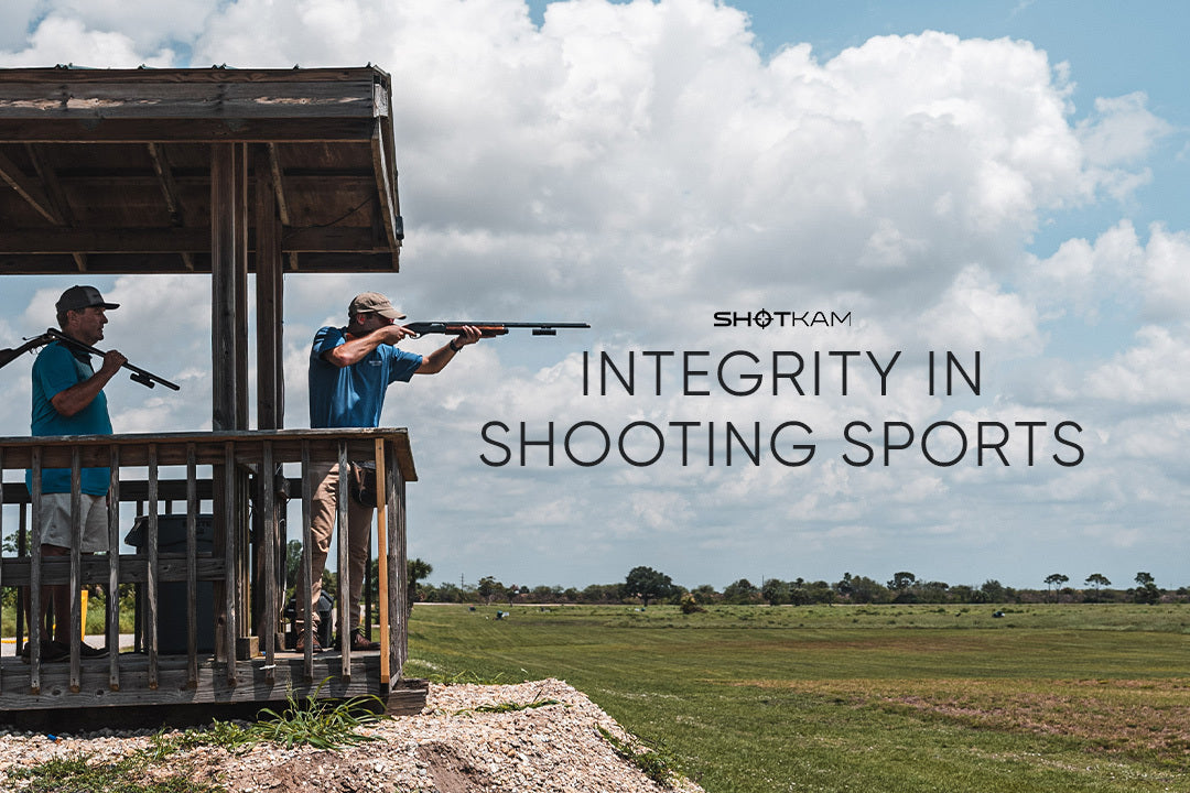 Integrity in shooting sports captured as two shooters aim at targets from a raised platform in a UK shooting range, equipped with ShotKam cameras.