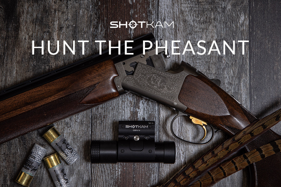 Over-and-under shotgun with cartridges and ShotKam Gen 4 camera, ready for an upland pheasant hunt in the UK.