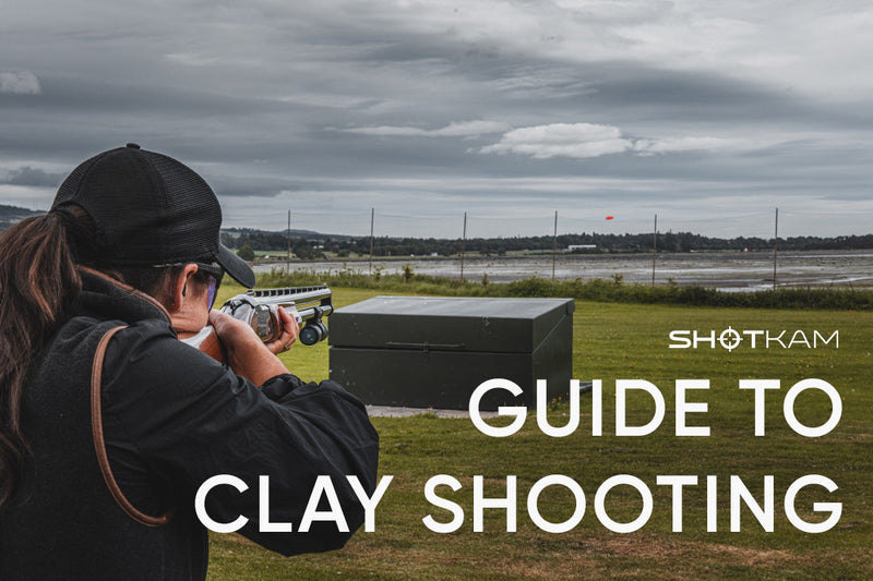 Woman practicing clay target shooting with a camera mounted on her shotgun