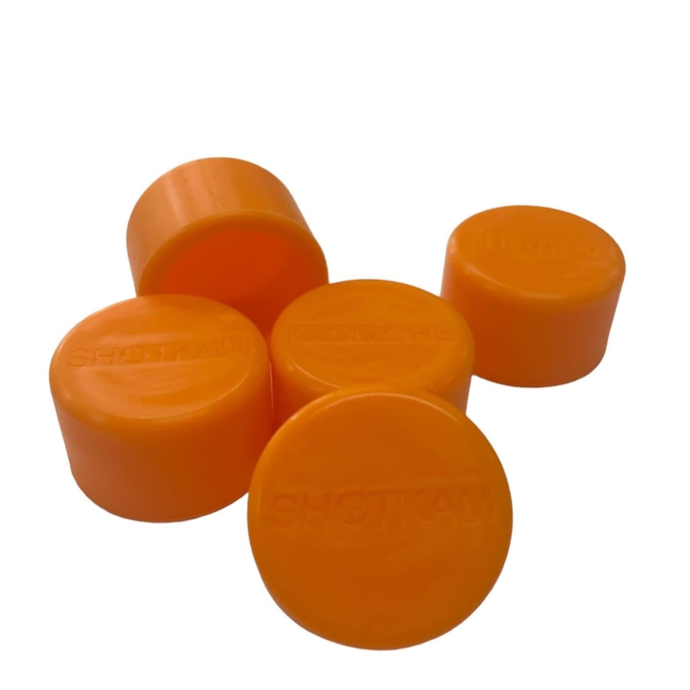 Pack of five soft plastic orange lens covers for ShotKam, designed to safeguard the camera lens.