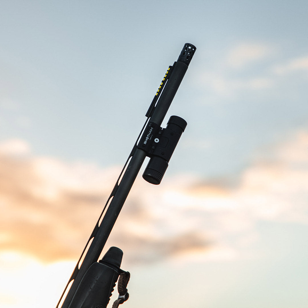 ShotKam Gen 4 camera mounted on a shotgun barrel against a sky backdrop. Designed for UK clay shooters and hunters to record and analyse shooting performance.