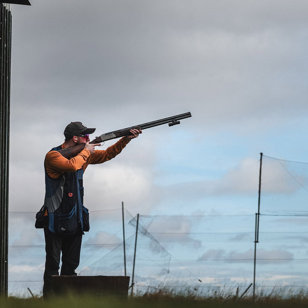 A UK shooter prepares for a clay pigeon target with a 12 gauge o/u shotgun fitted with the ShotKam Gen 4 Mini. Designed for British shooting sports, this camera provides real-time shot analysis to improve accuracy.