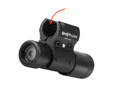 Close-up of the ShotKam Gen 4 Mini camera attached to a 12 Gauge mount. The red arrow indicates the rubber pads inside the mount, ensuring a secure and mark-free grip.