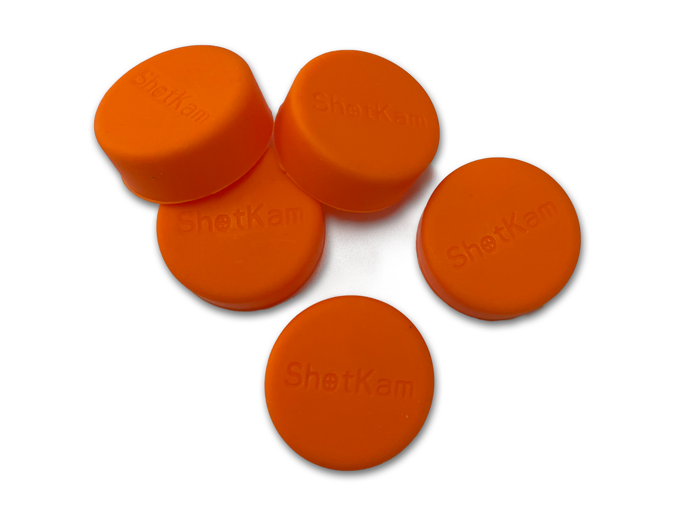 A set of five orange lens covers for ShotKam cameras, providing soft plastic protection for the lens.